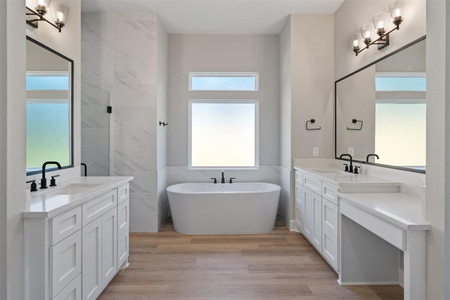 Primary Bath, Stand Alone Tub Soaking Tub surrounded by Marble, Dual Vanities including a Make Up Vanity, Custom Cabinets, Custom Framed Mirrors, Oil Rubbed Bronze Fixtures and Luxury Vinyl Plank on the Floors