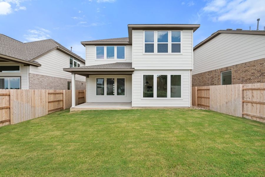Front exterior of a new home in Terrace Collection at Lariat, Liberty Hill, TX, highlighting curb appeal (Image 27). Front exterior of a new home in Terrace Collection at Lariat, Liberty Hill, TX, highlighting curb appeal (Image 27).