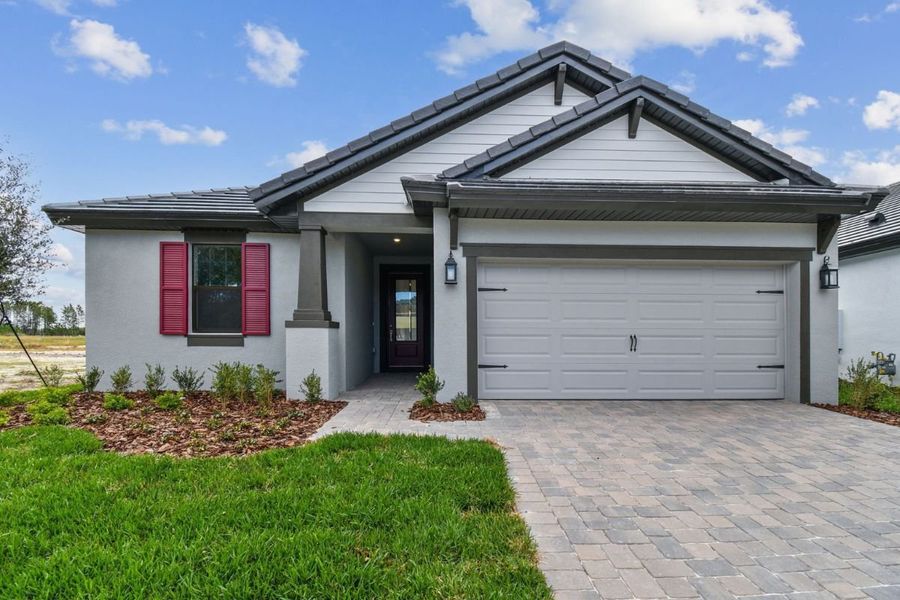 Front exterior of a new home in Tamarack at Two Rivers, Zephyrhills, FL, highlighting curb appeal (Image 2).