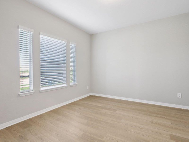 Spare room featuring light wood-style flooring and baseboards Spare room featuring light wood-style flooring and baseboards
