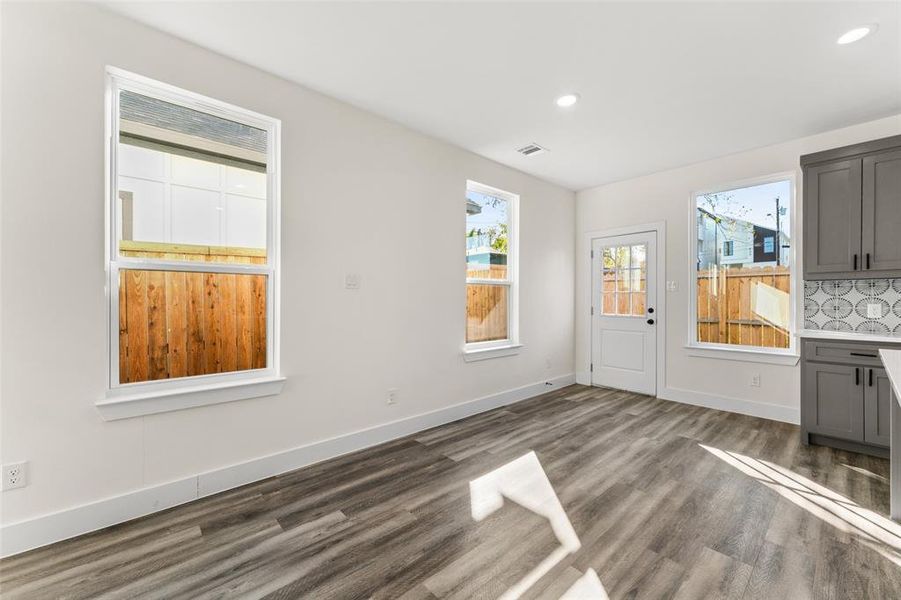 Unfurnished dining area featuring dark wood-style flooring and recessed lighting Unfurnished dining area featuring dark wood-style flooring and recessed lighting