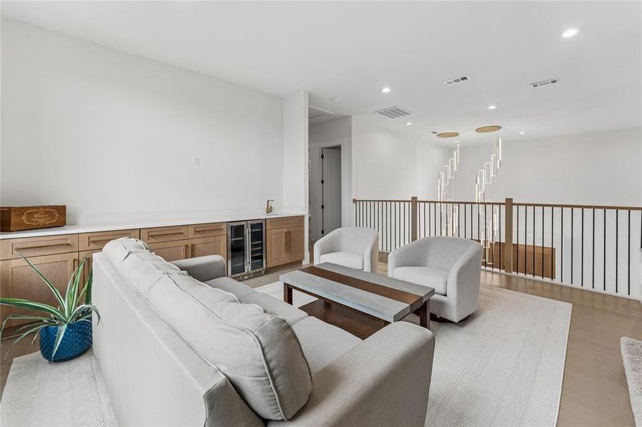 Family room with wet bar with cabinets, beverage refrigerator and sink Family room with wet bar with cabinets, beverage refrigerator and sink