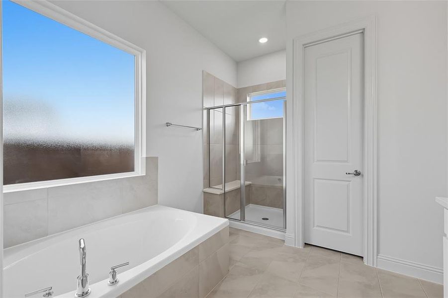 Full bath with a shower stall, a garden tub, and recessed lighting