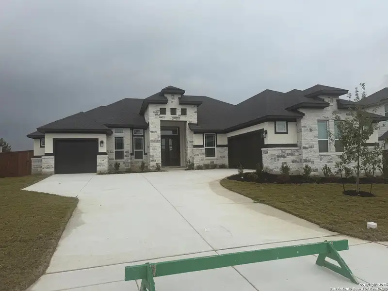 Front exterior of a new home in Mesa Western, Cibolo, TX, highlighting curb appeal (Image 2). Front exterior of a new home in Mesa Western, Cibolo, TX, highlighting curb appeal (Image 2).