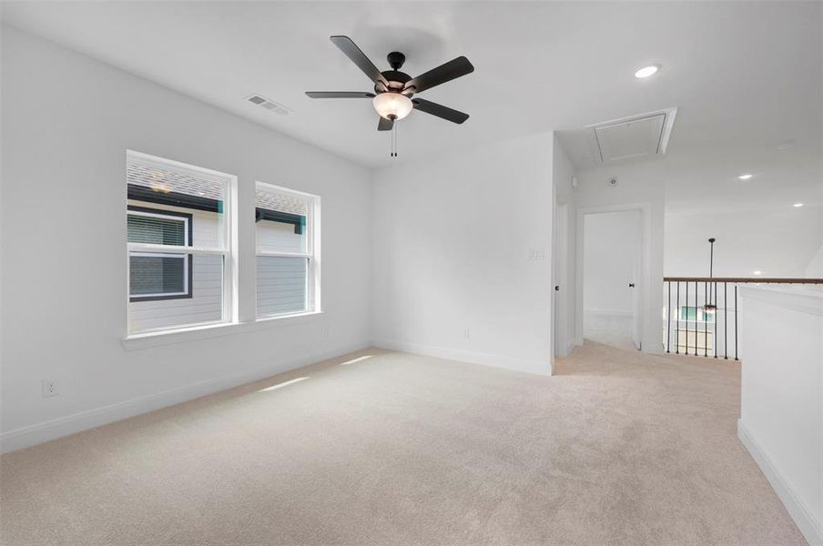 Empty room featuring light colored carpet, recessed lighting, and a ceiling fan