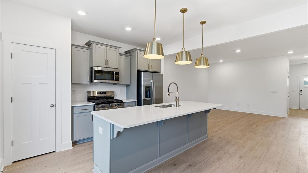 Superior craftsmanship shines in this modern kitchen with a large center island and open flow located at Silo Ridge