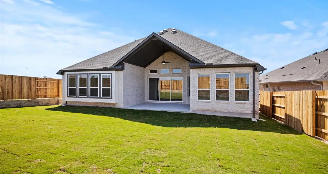 Representative exterior photo of a completed home built from the Farris by Chesmar Homes in 6 Creeks, Kyle, TX (Image 9).