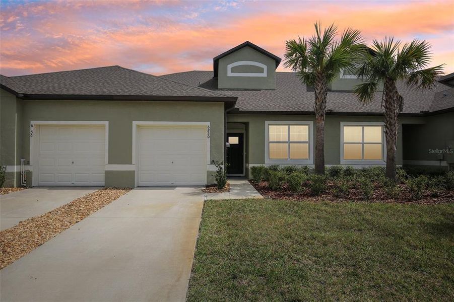 Front exterior of a new home in Abbott Square: The Villas, Zephyrhills, FL, highlighting curb appeal (Image 31). Front exterior of a new home in Abbott Square: The Villas, Zephyrhills, FL, highlighting curb appeal (Image 31).