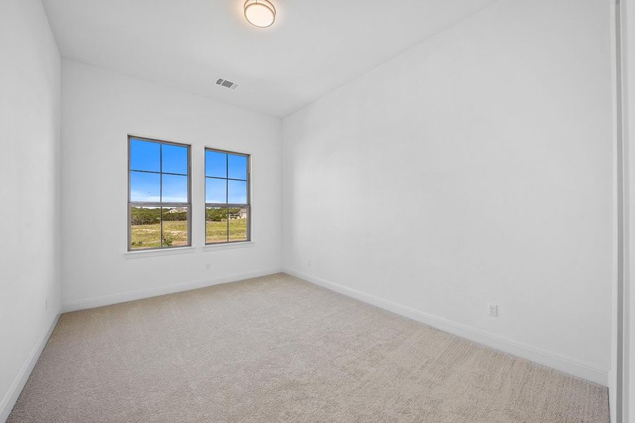 Ensuite 4 Empty room featuring light colored carpet and baseboards