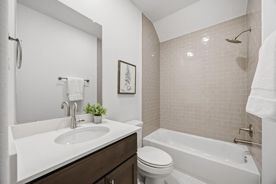 Classic Vibes: The chic Secondary Bath, nestled between the secondary bedrooms, offers a stylish and contemporary touch to your abode.