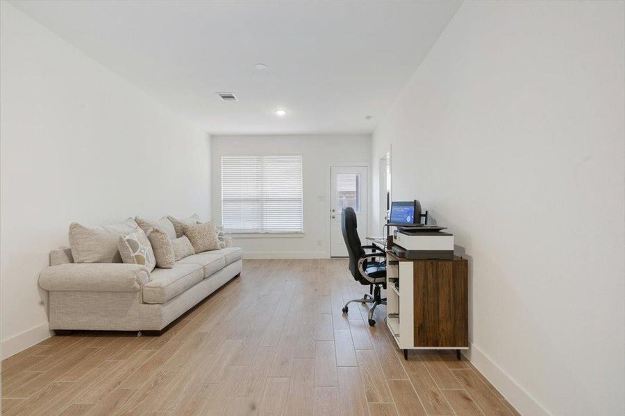 Furnished interior view inside a new home in Meridiana, Iowa Colony (Image 17).