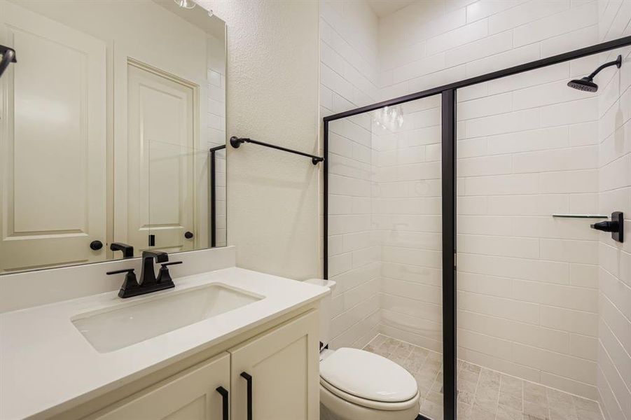 Bathroom with vanity and a stall shower