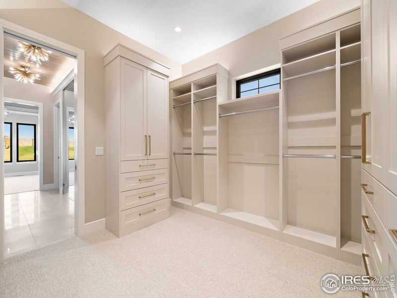 Primary Dream Closet with Custom Cabinetry and Accent Lighting