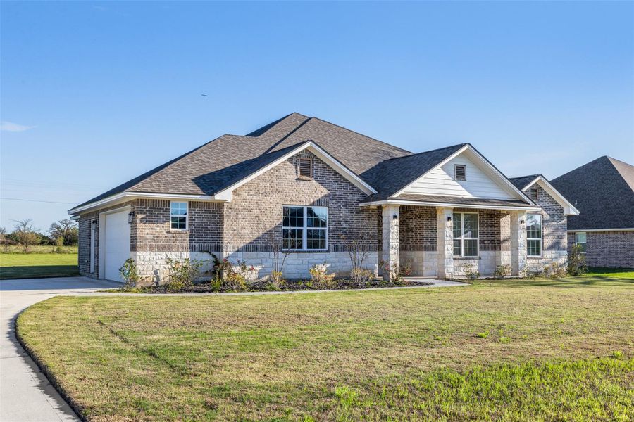 Front exterior of a new home in , Iola, TX, highlighting curb appeal (Image 21).