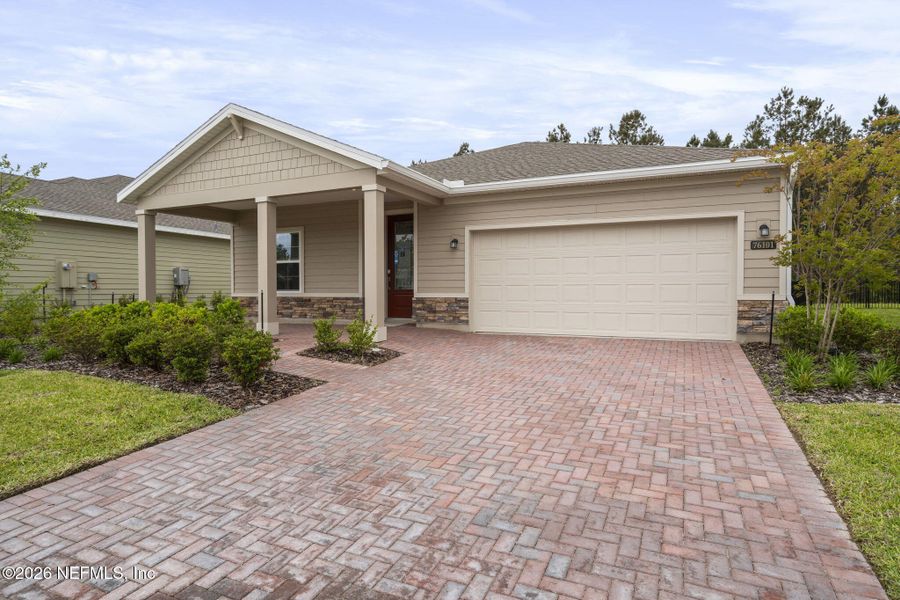 Front exterior of a new home in Tributary, Yulee, FL, highlighting curb appeal (Image 1). Front exterior of a new home in Tributary, Yulee, FL, highlighting curb appeal (Image 1).