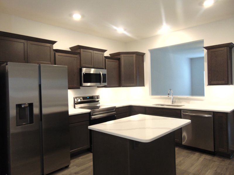 The kitchen is spacious and modern, it comes with steel appliances, and crown cabinetry for a unique look