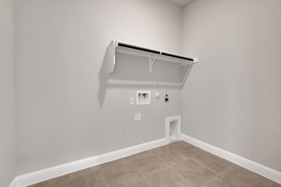 Laundry area with hookup for a gas dryer, hookup for an electric dryer, and washer hookup