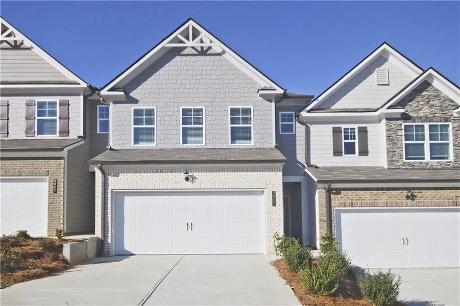 Front exterior of a new home in Somerset at Riverbrook, Gainesville, GA, highlighting curb appeal (Image 2). Front exterior of a new home in Somerset at Riverbrook, Gainesville, GA, highlighting curb appeal (Image 2).