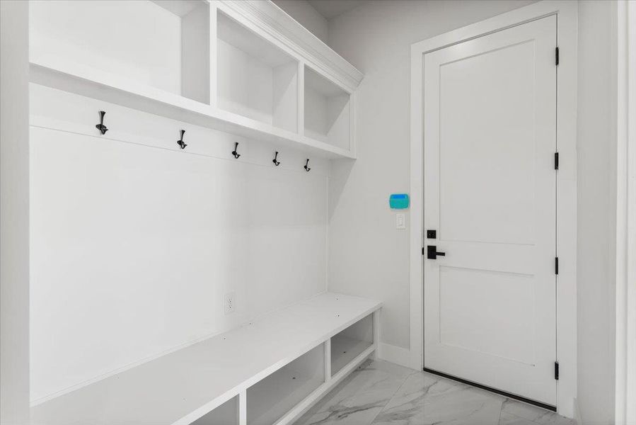 Mudroom featuring light marble finish floors and baseboards Mudroom featuring light marble finish floors and baseboards