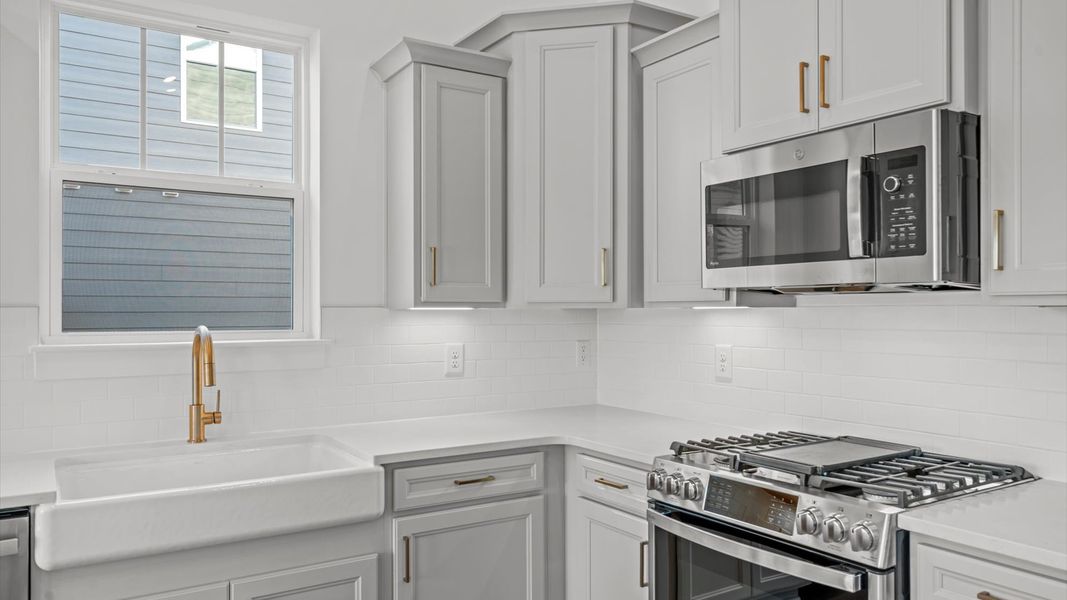 Tasteful kitchen with a streamlined island and modern finishes in a first-class DRB Homes design