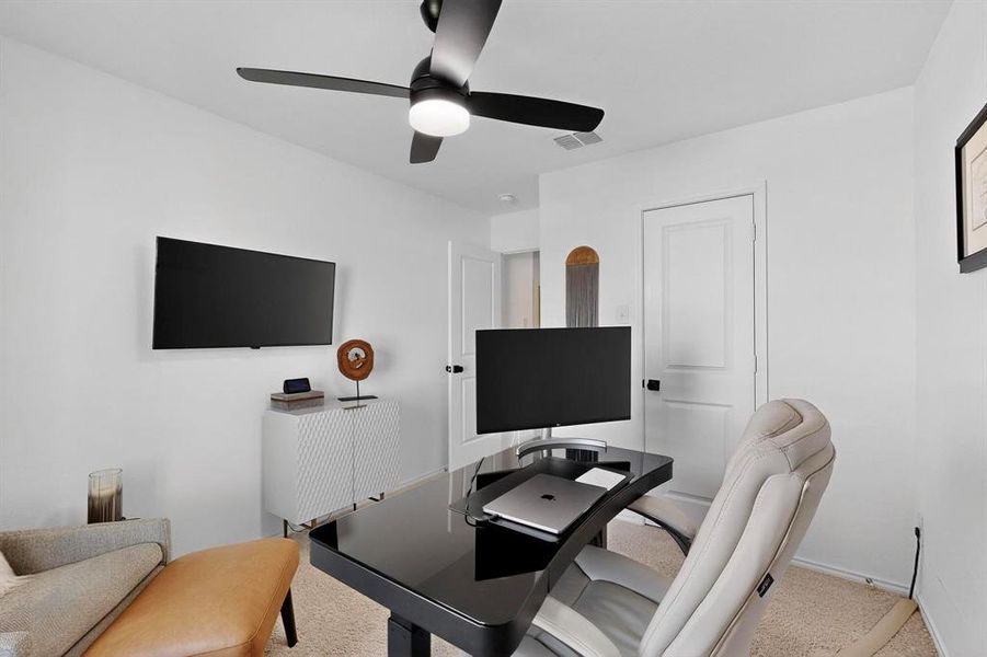 Carpeted office with a ceiling fan and baseboards Carpeted office with a ceiling fan and baseboards