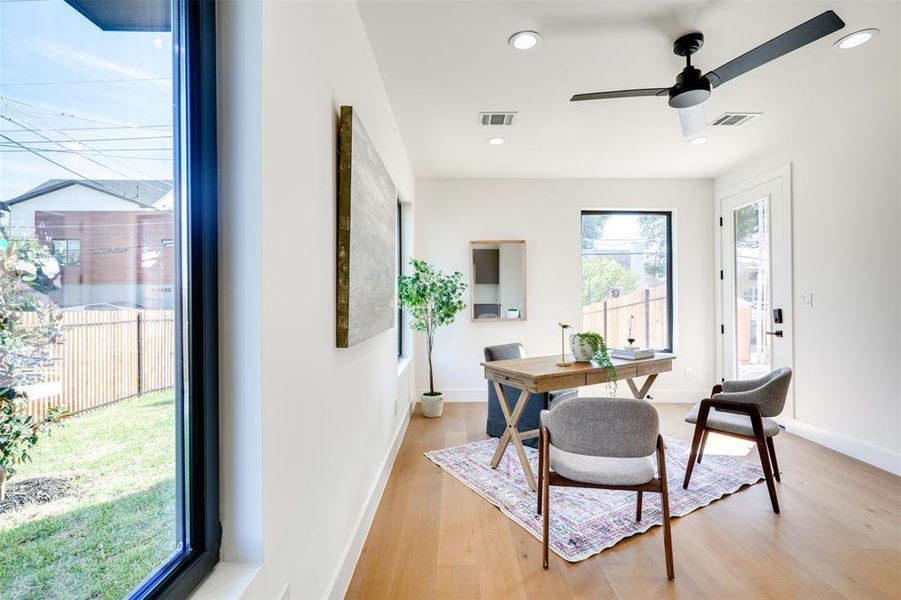 Dining area with ceiling fan and light hardwood / wood-style flooring