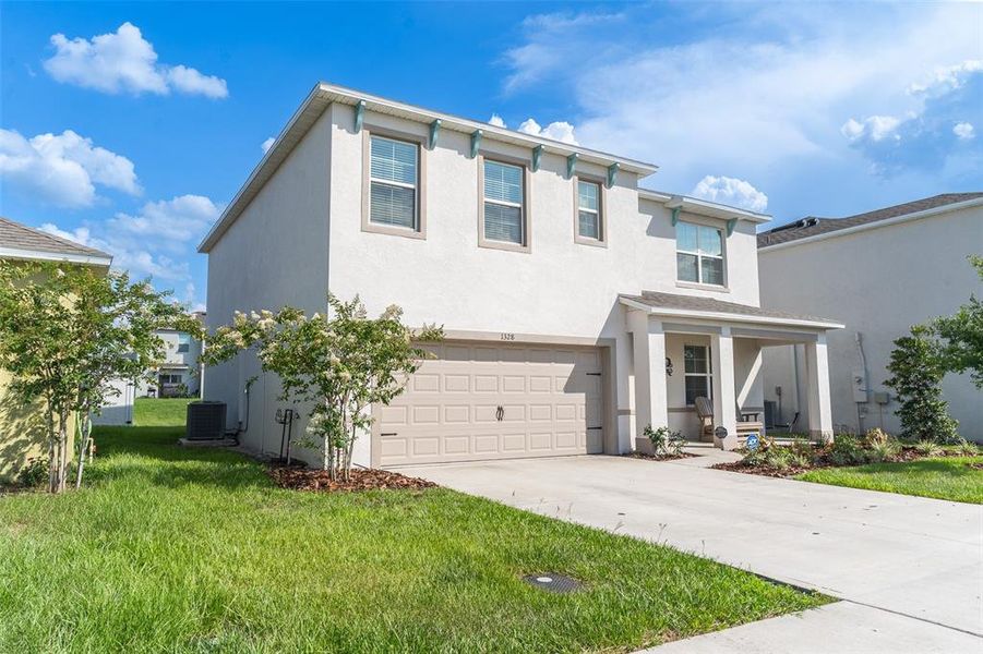 Front exterior of a new home in Harmony at Lake Eloise, Winter Haven, FL, highlighting curb appeal (Image 2). Front exterior of a new home in Harmony at Lake Eloise, Winter Haven, FL, highlighting curb appeal (Image 2).