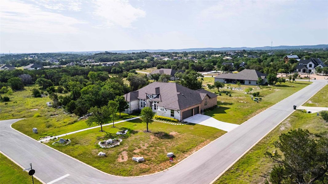 Front exterior of a new home in Spicewood Trails, Spicewood, TX, highlighting curb appeal (Image 1). Front exterior of a new home in Spicewood Trails, Spicewood, TX, highlighting curb appeal (Image 1).