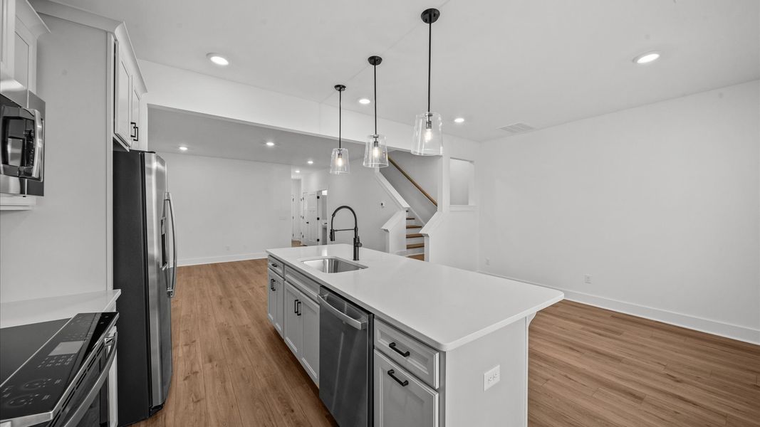 Accomplished kitchen design featuring pendant lighting above a statement island for both prep and gathering in Arden, NC