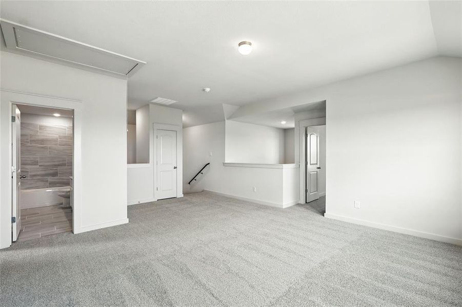 Spare room with light carpet and attic access Spare room with light carpet and attic access