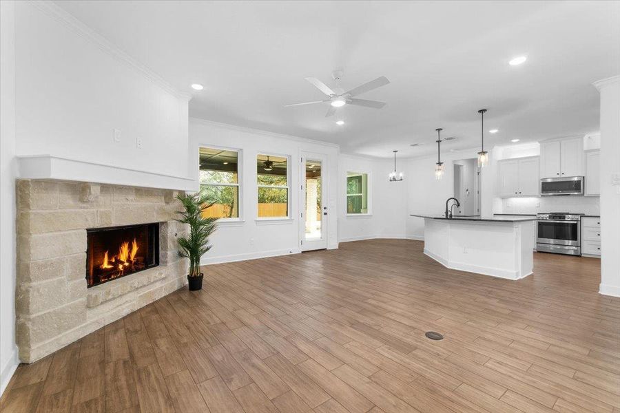 Unfurnished living room featuring ceiling fan, a fireplace, recessed lighting, baseboards, and ornamental molding Unfurnished living room featuring ceiling fan, a fireplace, recessed lighting, baseboards, and ornamental molding