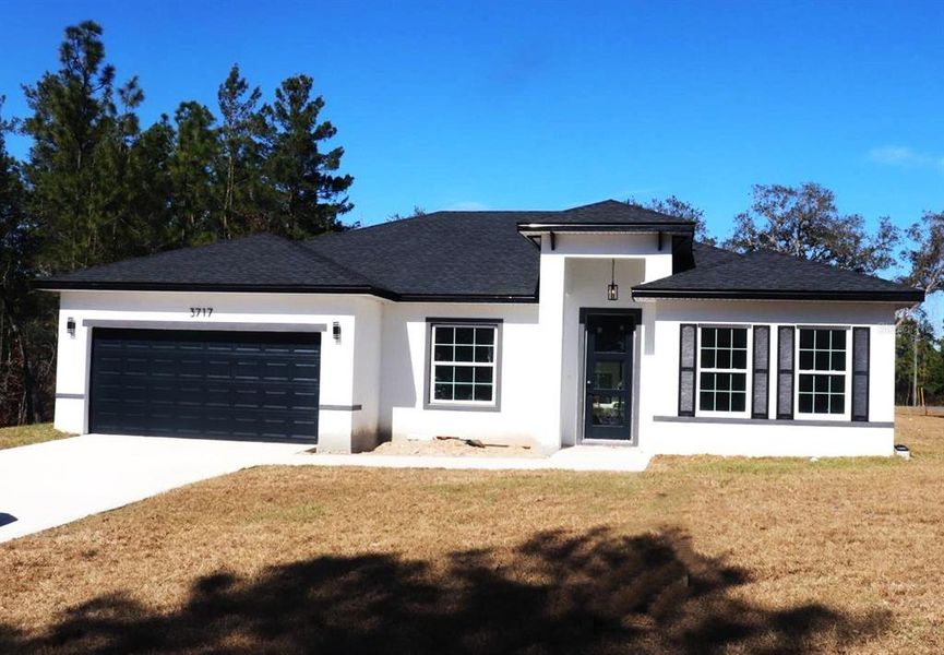 Front exterior of a new home in , Citrus Springs, FL, highlighting curb appeal (Image 1). Front exterior of a new home in , Citrus Springs, FL, highlighting curb appeal (Image 1).