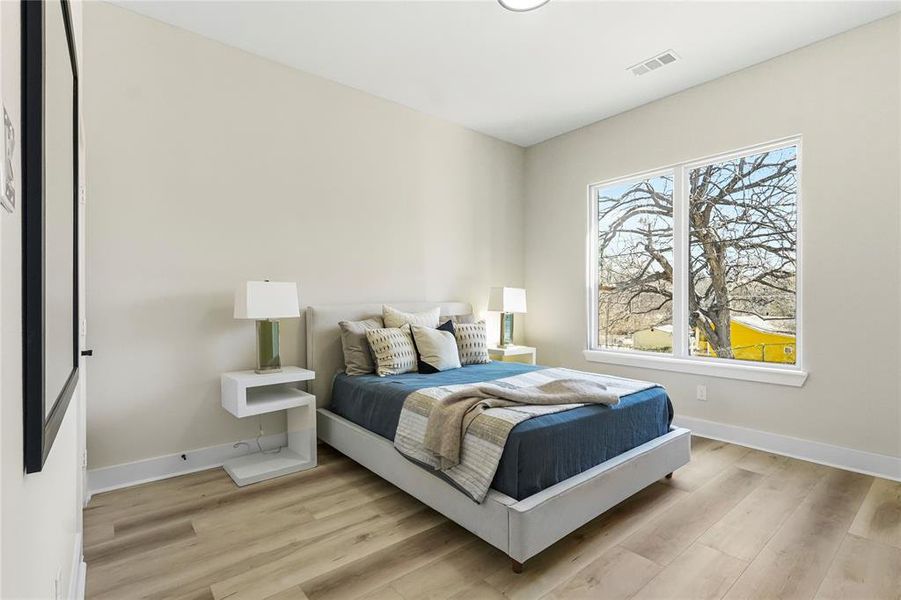 Bedroom with light wood-style floors and baseboards