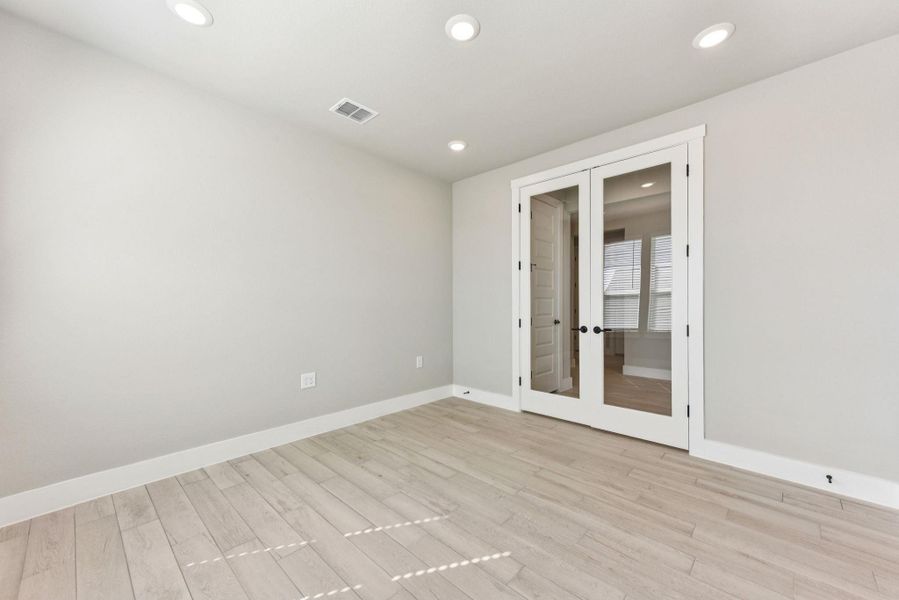 Unfurnished room with french doors, recessed lighting, and light wood-style floors