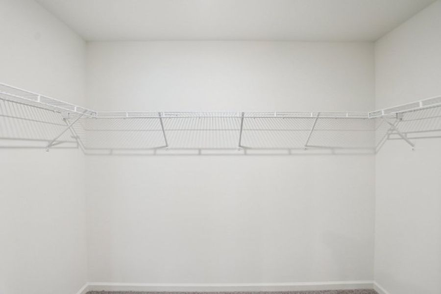 A white wall with a metal railing.