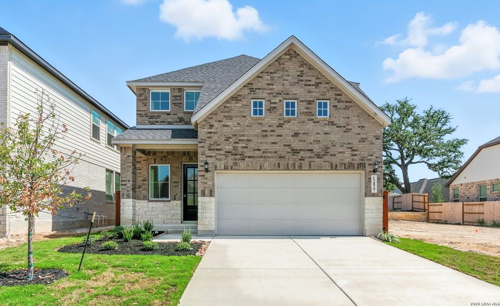 Front exterior of a new home in Stillwater Ranch, San Antonio, TX, highlighting curb appeal (Image 1). Front exterior of a new home in Stillwater Ranch, San Antonio, TX, highlighting curb appeal (Image 1).