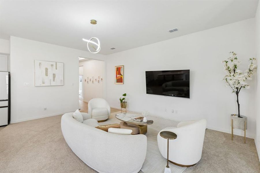 Living area featuring light-toned carpet flooring and a contemporary pendant light fixture