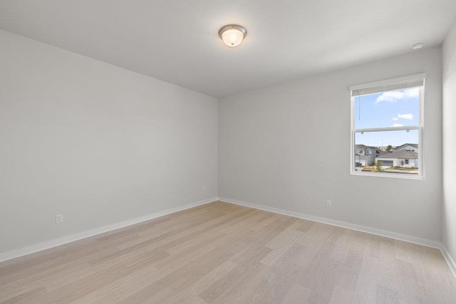 Unfurnished room featuring light wood-type flooring and baseboards