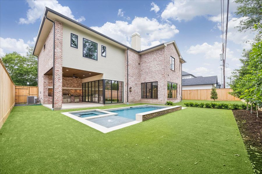 This outdoor space is perfect for entertaining with covered outdoor kitchen and pool.