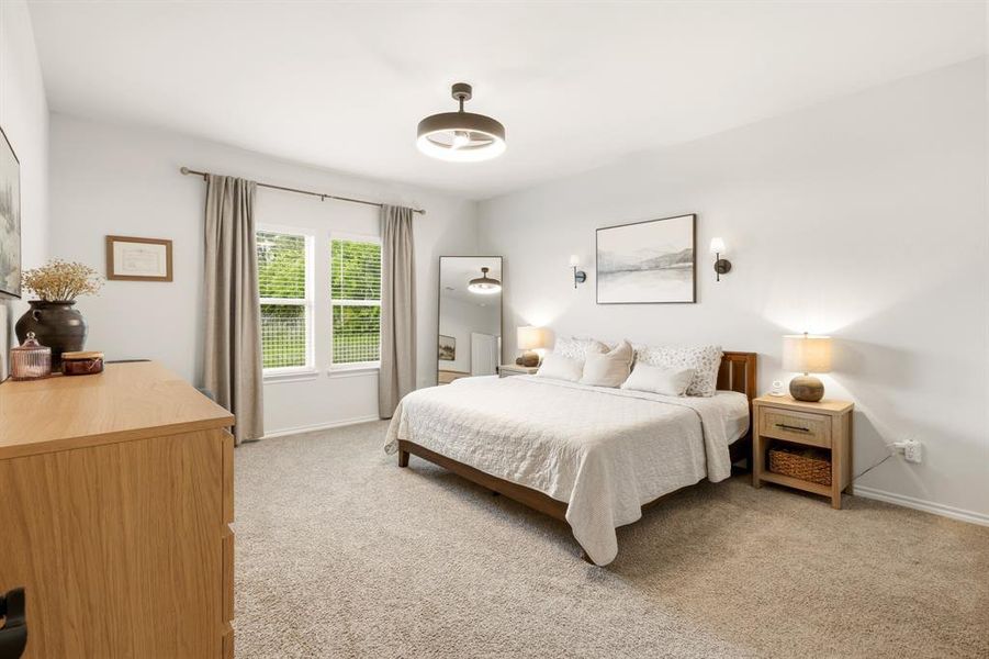 Spacious and thoughtfully designed, this oversized bedroom offers plenty of room to unwind—while large windows frame peaceful views of your expansive backyard, bringing in natural light and a sense of calm you’ll love coming home to Spacious and thoughtfully designed, this oversized bedroom offers plenty of room to unwind—while large windows frame peaceful views of your expansive backyard, bringing in natural light and a sense of calm you’ll love coming home to