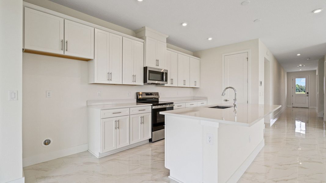 The Sweetgum Spacious and Bright Kitchen in two story home in Trailside in Mount Dora by DRB Homes
