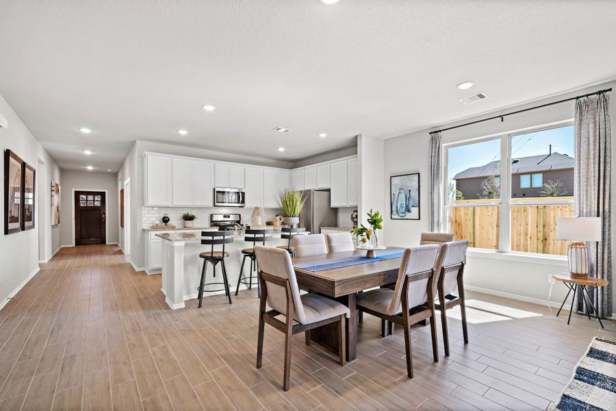 A large kitchen with a dining table.