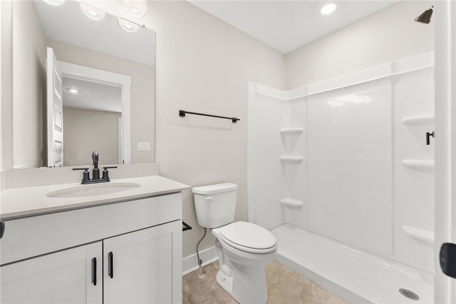 This functional bathroom features a single vanity,