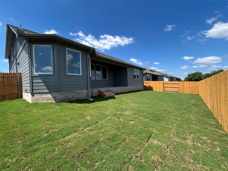 Back of house with a fenced backyard