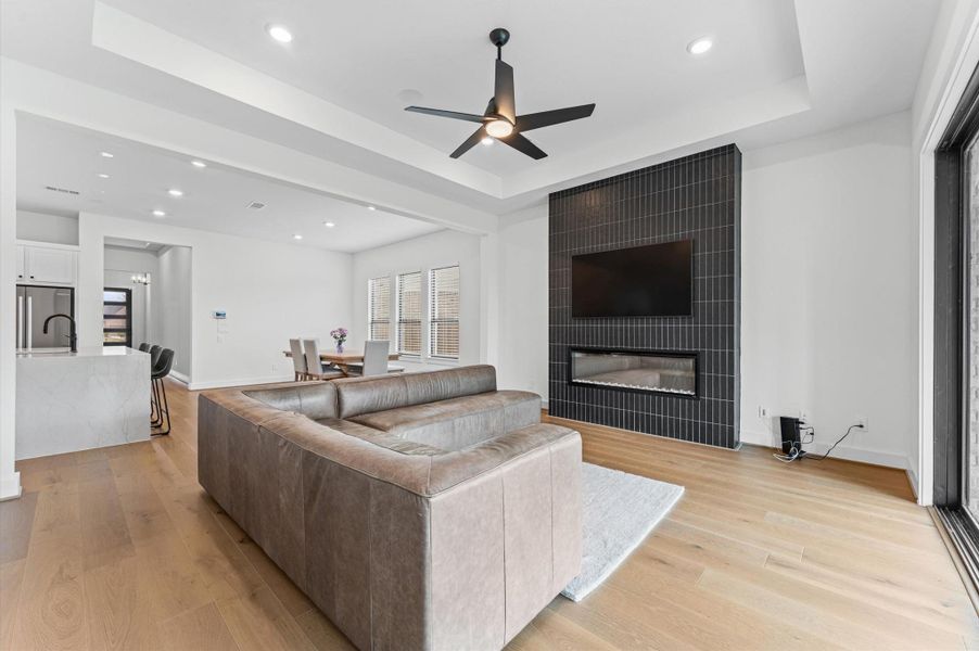 A warm focal point in the main living room — the fireplace with its modern dark surround adds character without trying too hard.