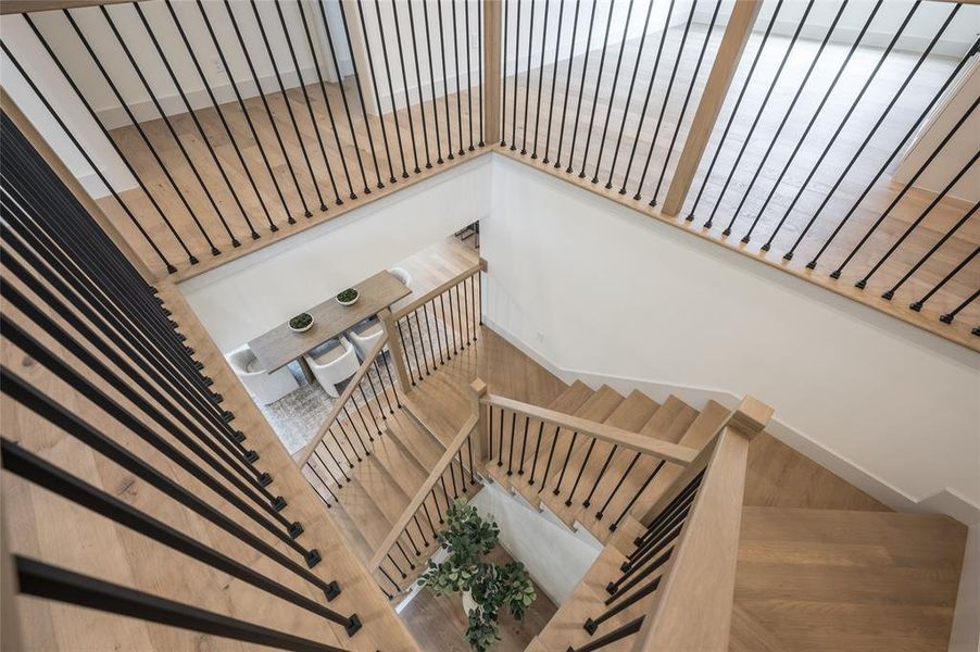 The central staircase adds an elegant focal point with beautiful oak andcontemporary blackened metal spindles.