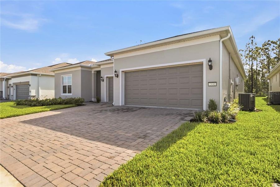 Front exterior of a new home in Del Webb Sunbridge, St. Cloud, FL, highlighting curb appeal (Image 27).