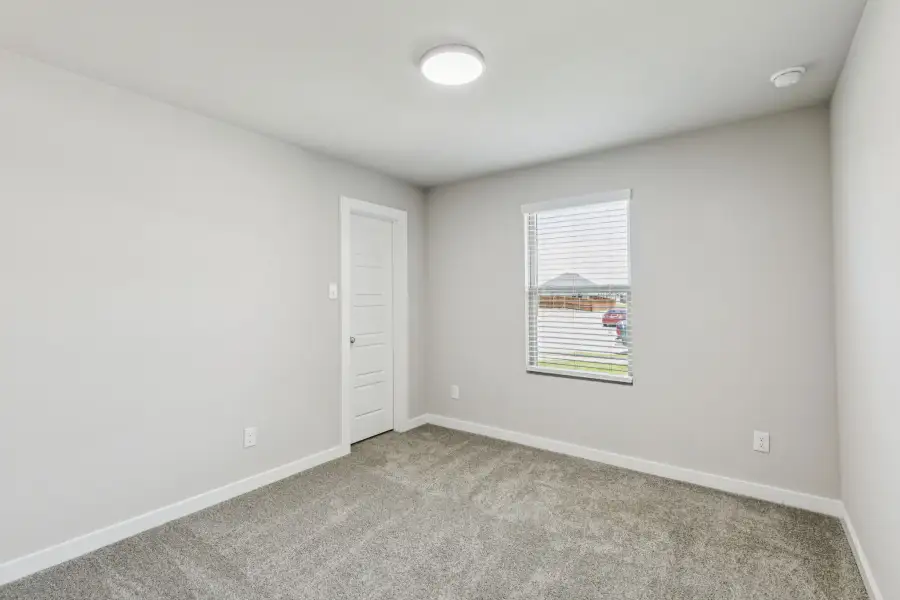 Bedroom in the Harper home plan by Trophy Signature Homes – REPRESENTATIVE PHOTO