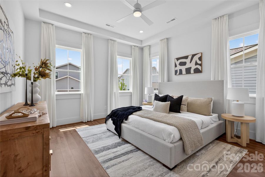 First floor primary bedroom is enhanced with tray ceiling, recessed lighting and an abundance of windows. First floor primary bedroom is enhanced with tray ceiling, recessed lighting and an abundance of windows.