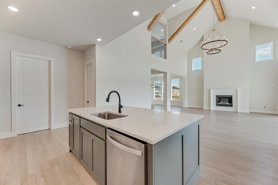 Kitchen with beam ceiling, dishwasher, light wood finished floors, high vaulted ceiling, and recessed lighting Kitchen with beam ceiling, dishwasher, light wood finished floors, high vaulted ceiling, and recessed lighting